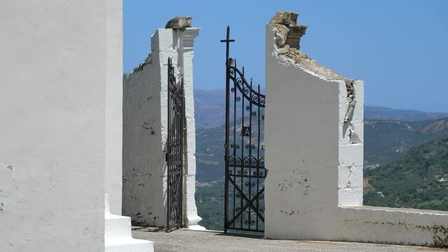 Dolly right revealing old church gate, beautiful landscape in background, Topolia