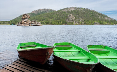 Boats on the shore of the lake in Burabay (Borovoye) National Park in Kazakhstan. Central Asia Travel.