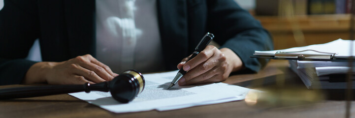Businesswoman lawyer working and reading agreement business to signing on contract in legal office
