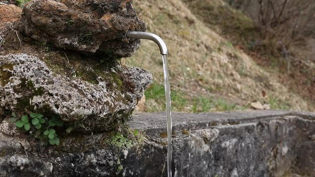 Source of water in the mountains. Natural source of clean fresh water close up. Environmental protection concept. Slow motion