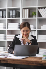 Business woman using calculator for do math finance on wooden desk in office and business working background, tax, accounting, statistics and analytic research concept..