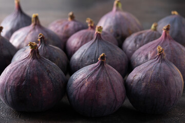 Fresh ripe purple fig fruits on dark background.