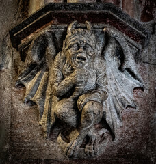 Ancient stone demon sculpture. Gothic church decoration