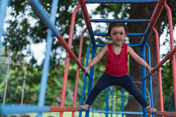 Fototapeta premium Kids playing on outdoor playground, kids playing in school or kindergarten, kids active on colorful slides and swings, healthy summer activities for kids.