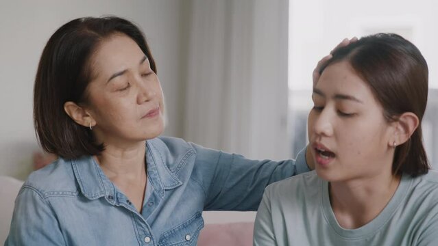 Middle aged asia people old mom love care trust comfort help young teen talk crying stress relief at home. Mum as friend listen adult child woman feel pain sad worry of broken heart life crisis issues