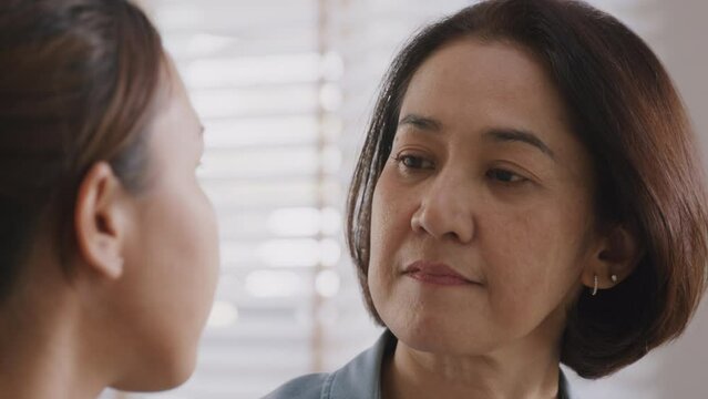 Middle aged asia people old mom love care trust comfort help young teen talk crying stress relief at home. Mum as friend listen adult child woman feel pain sad worry of broken heart life crisis issues