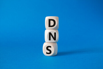 DNS -Domain Name Server - Consumer Price Index symbol. Concept word DNS on wooden cubes. Beautiful...