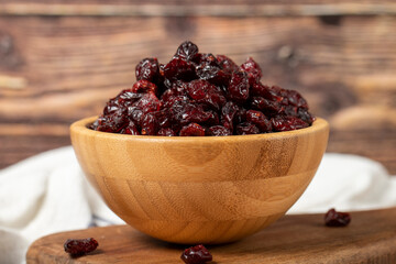 Dried Cranberry in bowl. Organic farm products. Sun-dried Cranberry on dark background. Close up