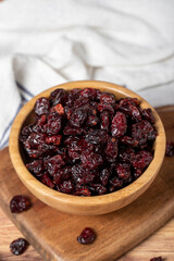 Dried Cranberry in bowl. Organic farm products. Sun-dried Cranberry on dark background. Close up