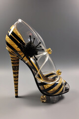 weird hight heels in yellow and black colors with bee brooch
