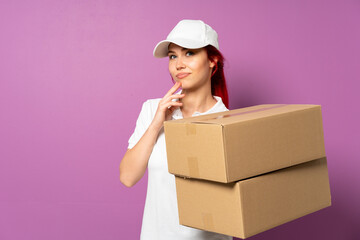Teenager delivery girl isolated on purple background scheming something