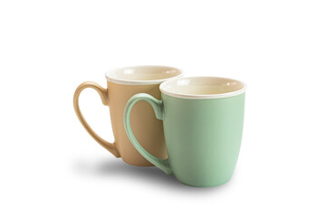 View of two empty ceramic coffee mugs brown and green isolated on white background with clipping path.