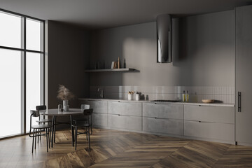 Brown kitchen interior with dinner table, kitchenware and shelves