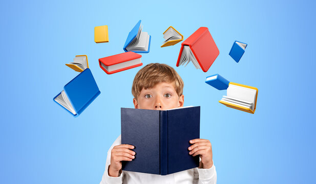 Kid with book in hands on blue background, education and creativity