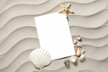 Blank card, seashells and starfish on sand