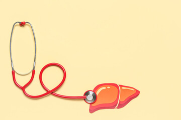 Red paper liver with stethoscope on orange background