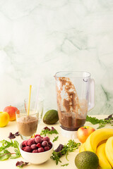 Healthy breakfasts, healthy delicious smoothie with frozen cherries and bananas and avocado, pea protein and mixed greens, smoothie jar mixer