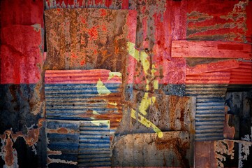 Abstract background image of Angola painted flag on rusty corrugated iron sheets
