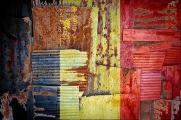 Abstract background of the flag of Belgium painted on rusty corrugated iron sheets