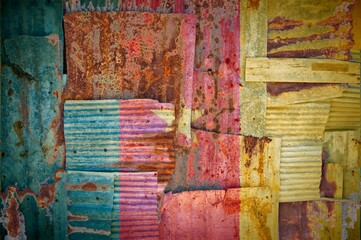 Abstract background of the flag of Cameroon painted on rusty corrugated iron sheets