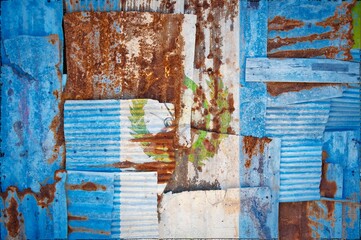 Abstract background of the flag of Guatemala painted on rusty corrugated iron sheets