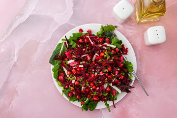 Healthy breakfasts or lunches, baked chickpeas and beetroot salad with goat cheese, mix of herbs and different seeds, top view, copy space