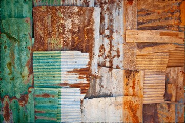 Flag of Ireland on rusty corrugated iron sheets forming a wall or a fence