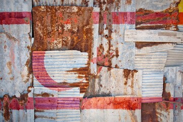 Shot of the flag of Northern Cyprus painted on rusty overlapping corrugated iron sheets