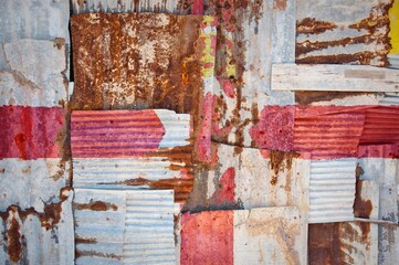 Shot of the flag of Northern Ireland painted on rusty overlapping corrugated iron sheets