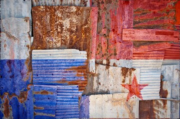 Shot of the flag of Panama painted on rusty overlapping corrugated iron sheets