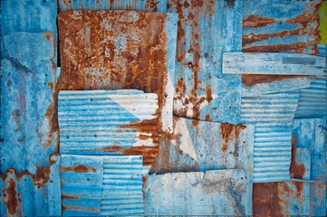 Flag of Somalia painted onto rusty corrugated iron sheets overlapping to form a wall or fence