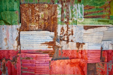Flag of Somaliland painted onto rusty corrugated iron sheets overlapping to form a wall or fence