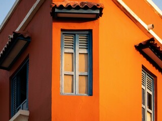 Fototapeta na wymiar Closeup of a window on an orange building