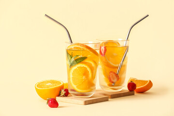 Fototapeta Glasses of infused water with orange slices on beige background obraz