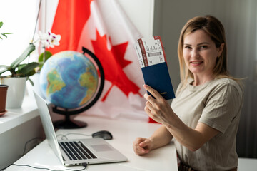 Young female student with Canadian flag and laptop with space for text