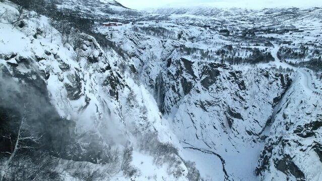 Aerial video of rocky snowy mountains, Voringfossen, Norway