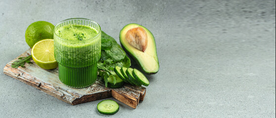 blended green smoothie on a light background. Long banner format. top view