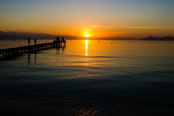 Fototapeta premium Silhouette of dock in sea during sunset
