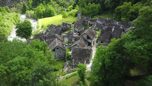 Aerial shot of the buildings in Corippo village surrounded by green vegetation