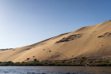 Beautiful landscape of Nile river near the desert on a sunny morning