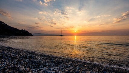 Beautiful view of the beach by the golden sea in Sicily, Italy at sunset