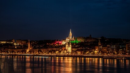 Obraz na płótnie Canvas View of the illuminated skyline of Budapest, Hungary at the night reflected in waters