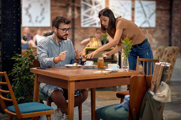 Young students in cafeteria, enjoying coffee. Man and woman together.