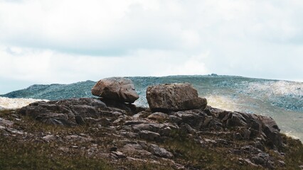 Peak of rocky mountain with blue sky in the background