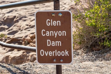 Closeup shot of a brown metal Glen Canyon Dam Overlook sign