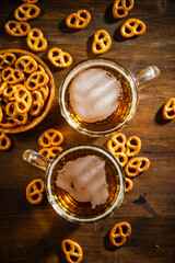 Beer in glasses with salted pretzels.