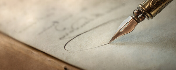 Fountain pen on an antique handwritten letter. Vintage nib pen and handwritten english cursive...