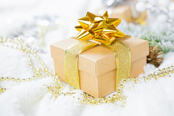 gift boxes packing with a bow and ribbon of gold color and decorations with ornament  balls on the...