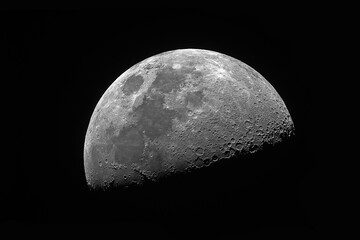 The first quarter Moon phase, taken with refractor telescope, black space background.