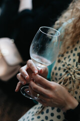 White wine poured into a glass by a waiter at a tasting in a restaurant. - 606766344